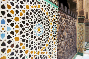 Detail of a wall ornamented with tiles in the Madrasa Bou Inania, in Fez, Morocco