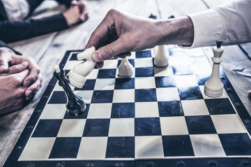 Business people playing chess