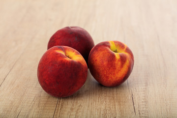 Fototapeta na wymiar Peaches on a wooden surface