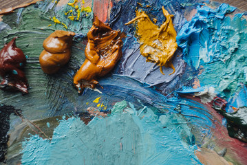 Closeup of paint mixing process in art workplace.