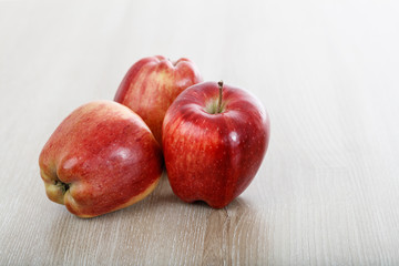 apples on a wooden surface