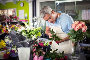 Male florist arranging flowers