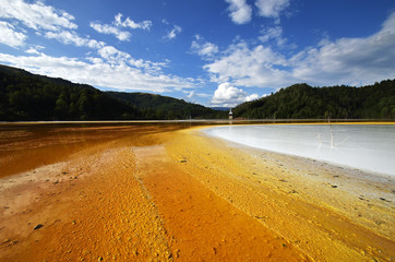 flooded church in toxic red polluted lake due to copper mining, Geamana village, Romania