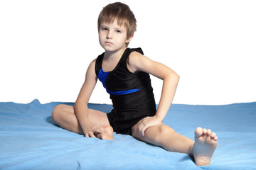 The boy does gymnastics