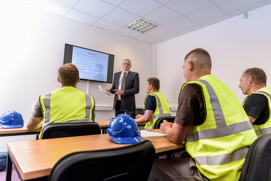 Apprentice builders in presentation in training facility