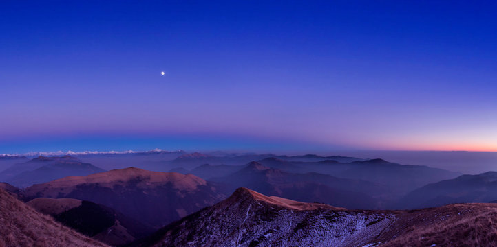 Elevated panoramic mountain landscape with valley mist at dawn, Monte Generoso,Ticino, Switzerland