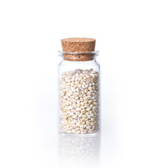 the organic wheat  rice in transparent glass bottle on white background