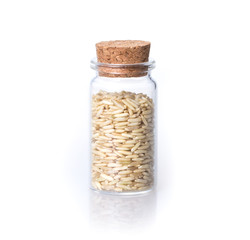 the organic  rice in transparent glass bottle on white background