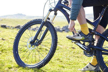 Cropped view of cyclists legs on bicycle