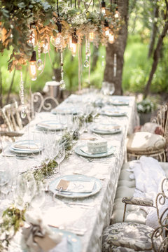 Laid table for a wedding under trees