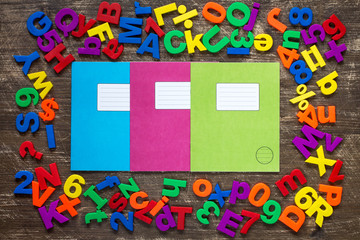 Exercise books with colorful letters and numbers