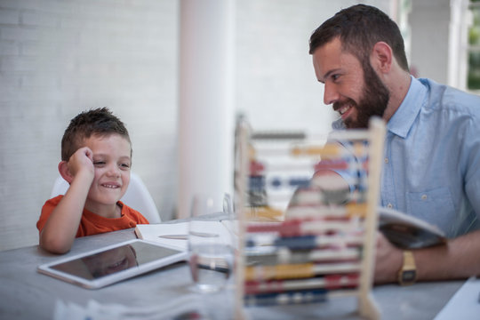Father teaching son to use abacus