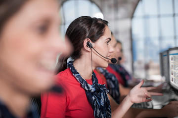 Row of female telephonists working in call centre