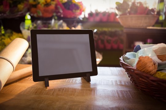 Wicker basket and digital tablet on the wooden table