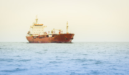 Obraz premium Cargo ship sailing in still water
