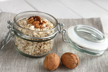 Oat flakes and nuts in a glass jar