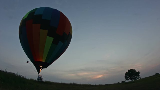 Hot air balloon takes off at sunset