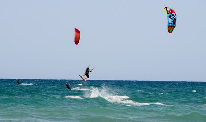 People practicing kitesurf on the beach of Torre Canne