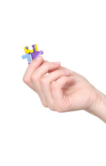 Hand holding puzzle piece on white background