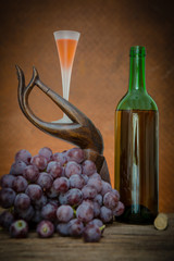 Wine glass and red grape with old steel background