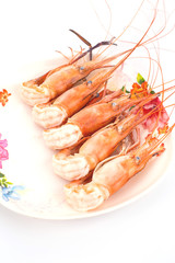 shrimp boil orange in plate isolated on white background.