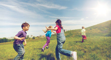 group of happy kids running outdoors