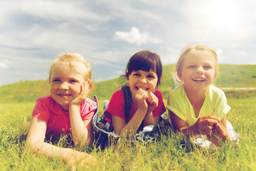 group of kids lying on blanket or cover outdoors