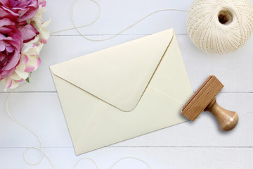 Mockup of envelope with a rubber stamp next to it.