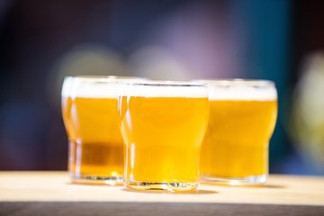 Three beer glasses on the bar counter
