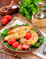 Potato sausage with vegetables on a wooden background.