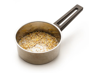 Cooking healthy porridge in metal pot