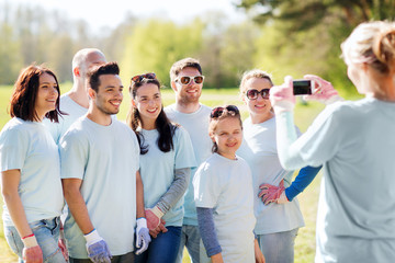 group of volunteers taking picture by smartphone