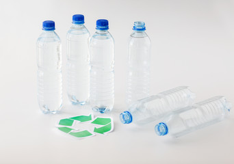 close up of plastic bottles and recycling symbol