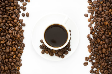 Coffee cup and beans isolated on a white background.

