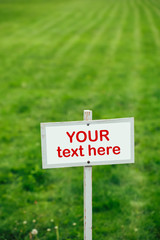 your text here sign against green lawn background