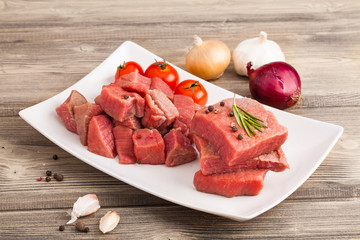 Raw beef steak on wooden table