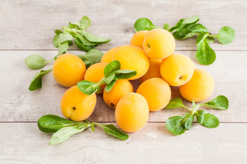 Fresh apricots on wooden background