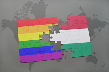 puzzle with the national flag of italy and gay rainbow flag on a world map background.