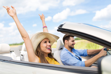 Happy Couple Driving in Convertible
