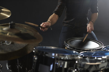 Close Up Of Drummer Playing Drum Kit In Studio