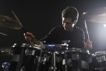 Young Drummer Playing Drum Kit In Studio