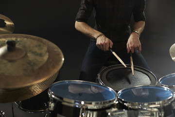 Fototapeta na wymiar Close Up Of Drummer Playing Snare Drum On Kit In Studio