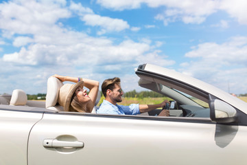 Happy Couple Driving in Convertible
