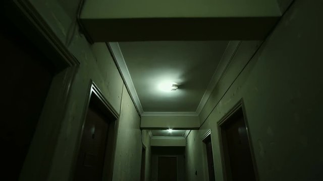 Tracking in on the corridor of an old apartment building,long and dark hallway..