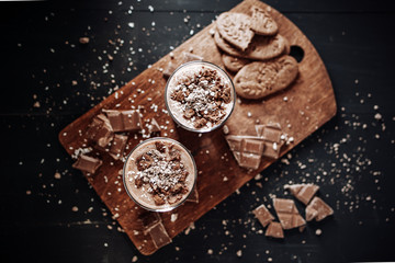 Cup with hot chocolate and chocolate chip cookies. Sweet chocolate dessert. Top view point