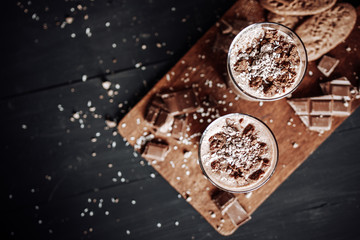 Cup with hot chocolate and chocolate chip cookies. Sweet chocolate dessert