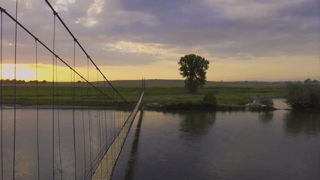 Aerial view of an old suspension bridge at dawn