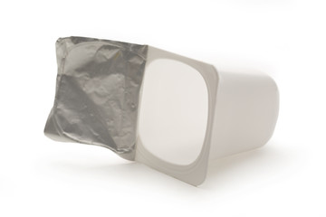Empty crushed plastic yogurt pot