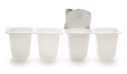Empty crushed plastic yogurt pots