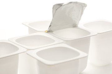 Empty crushed plastic yogurt pots